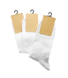 New pairs of cotton socks on white background, top view