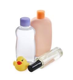 Baby oil, toiletries and toy duck on white background