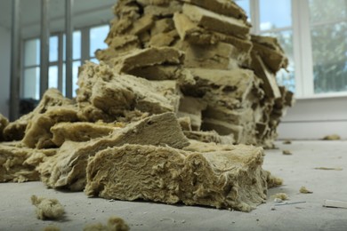 Photo of Heap of thermal insulation material in room, closeup