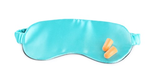 Pair of ear plugs and light blue sleeping mask on white background