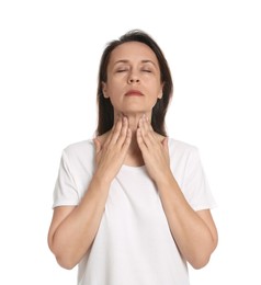 Mature woman doing thyroid self examination on white background