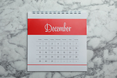 December calendar on marble background, top view