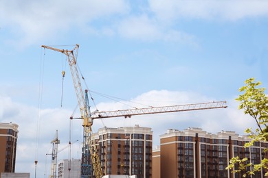 Construction site with tower crane near building