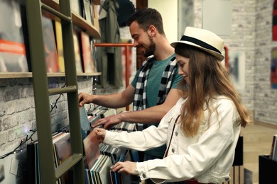 Young people choosing vinyl records in store