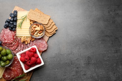 Photo of Snack set with delicious Parmesan cheese on grey table, top view. Space for text