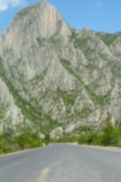 Big mountains and bushes near road, blurred view