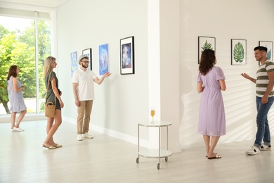 Group of people at exhibition in art gallery
