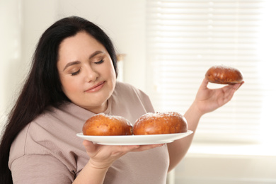 Lazy overweight woman with buns at home