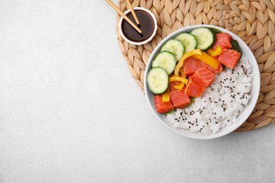 Photo of Delicious poke bowl with salmon, rice and vegetables on white table, top view. Space for text
