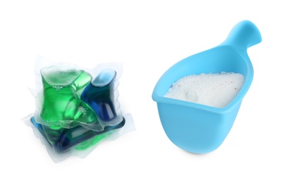 Laundry capsules and measuring scoop of washing powder on white background