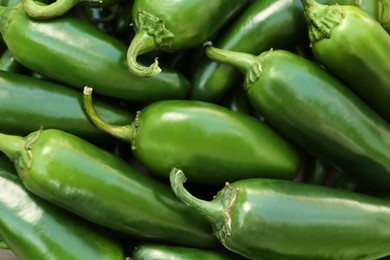 Photo of Green hot chili peppers as background, closeup