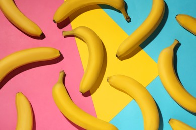 Ripe yellow bananas on color background, flat lay