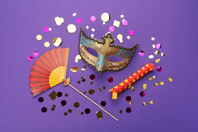 Flat lay composition with carnival items on purple background