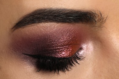 Photo of Young woman with evening makeup, closeup. Eye shadow product