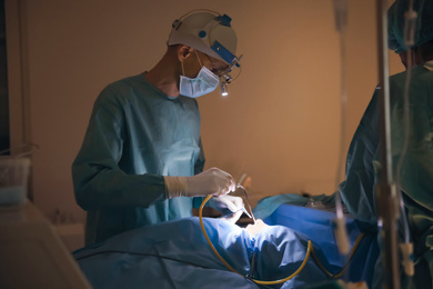 Professional doctors performing operation in surgery room
