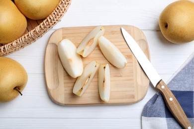 Cut and whole apple pears on white wooden table, flat lay