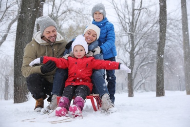Photo of Portrait of happy family outside on winter day. Christmas vacation