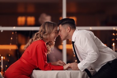 Lovely couple having romantic dinner on Valentine's day in restaurant