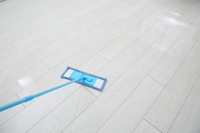 Washing of parquet floor with mop. Space for text