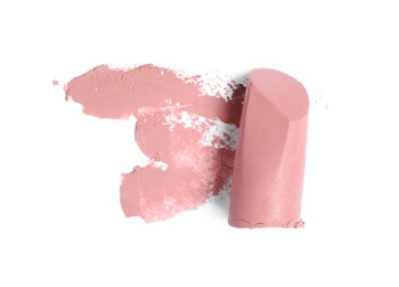 Photo of Nude color lipstick and smear on white background, top view