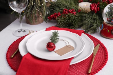Photo of Luxury place setting with beautiful festive decor for Christmas dinner on white table, closeup