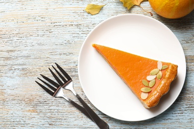 Flat lay composition with fresh delicious homemade pumpkin pie on wooden background