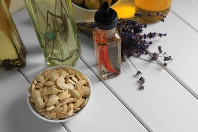 Different cooking oils and ingredients on white wooden table