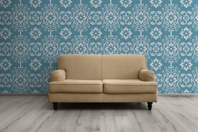 Modern sofa near patterned wallpapers. Interior design 