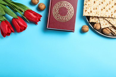 Flat lay composition with matzos on light blue background, space for text. Passover (Pesach) celebration