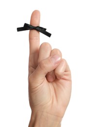 Photo of Woman showing index finger with tied black bow as reminder on white background, closeup