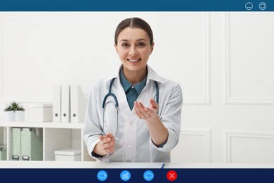 Pediatrician consulting patient online using video chat in clinic, view from webcam
