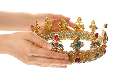 Woman holding beautiful golden crown on white background, closeup. Fantasy item