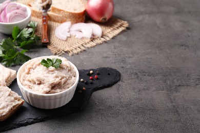 Photo of Delicious lard spread in bowl on grey table. Space for text