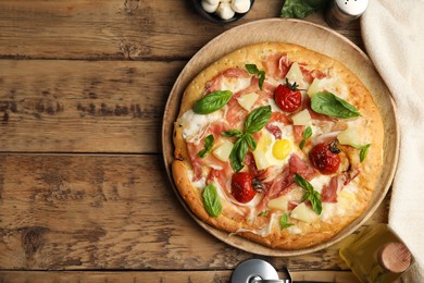 Pita pizza with prosciutto, pineapple, grilled tomatoes and egg on wooden table, flat lay. Space for text