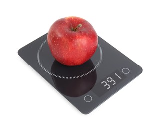 Ripe red apple and electronic scales on white background