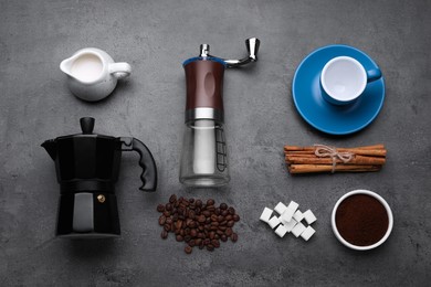 Photo of Flat lay composition with manual grinder and geyser coffee maker on black table