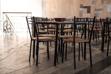 Simple cafeteria interior with set of stylish furniture