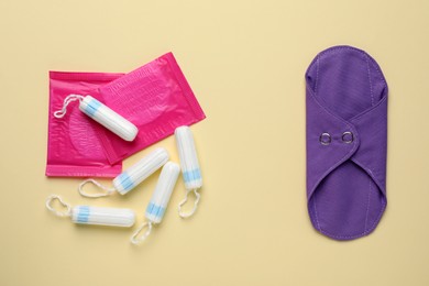 Different menstrual hygiene products on beige background, flat lay
