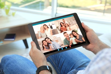 Man having online meeting with family members via videocall application indoors, closeup