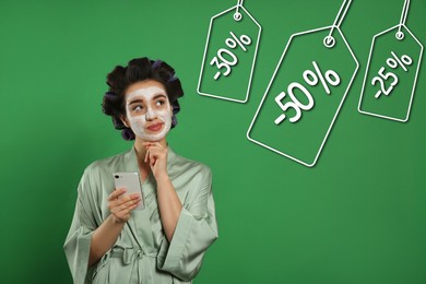 Young woman and tags with discounts on green background. Special promotion