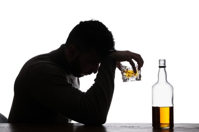 Silhouette of addicted man with alcoholic drink on white background