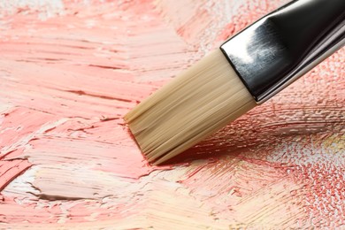 Photo of Painting beautiful strokes of colorful oil paints on canvas, closeup