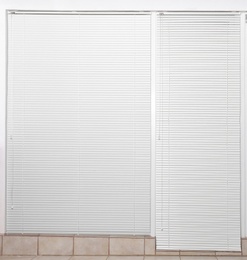 Window with closed white horizontal blinds indoors