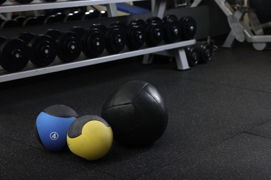 Different medicine balls on floor in gym