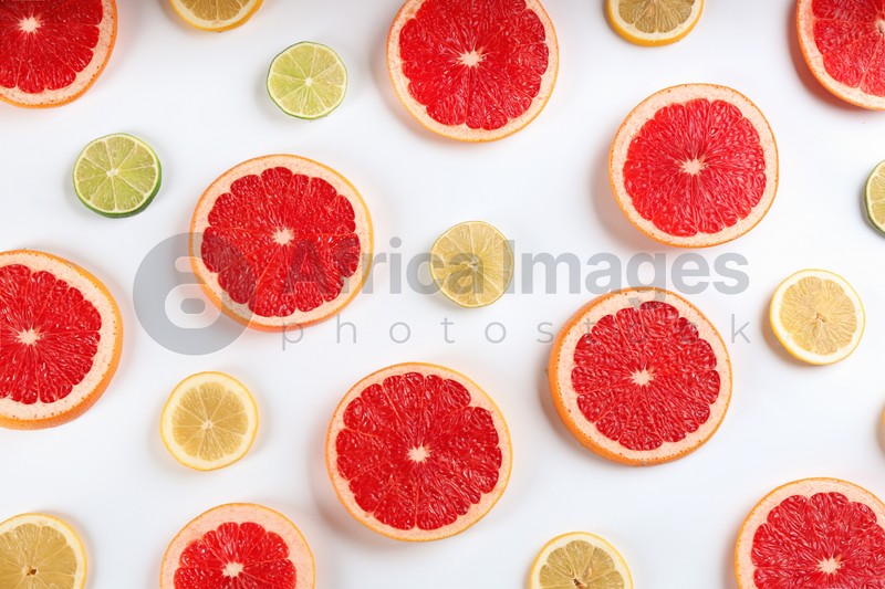 Flat lay composition with tasty ripe grapefruit slices on white background