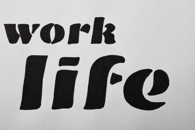 Work, Life written on white background, top view. Balance concept
