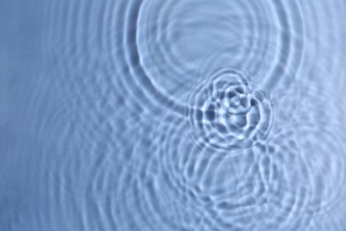 Closeup view of water with circles on blue background
