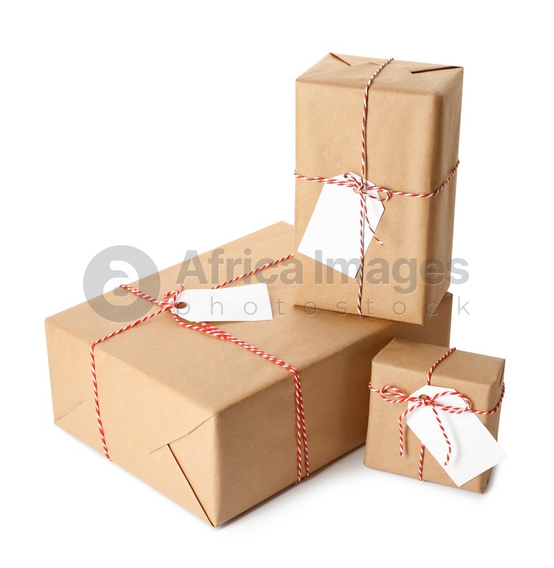 Gift boxes wrapped in kraft paper with tags on white background