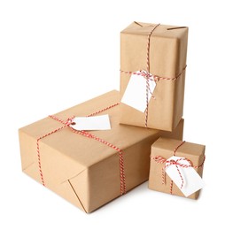 Photo of Gift boxes wrapped in kraft paper with tags on white background