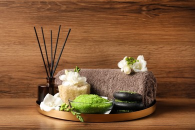 Photo of Aromatic sea salt and spa products on wooden table